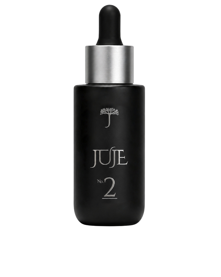 Black serum bottle with dropper labeled Juje on a background